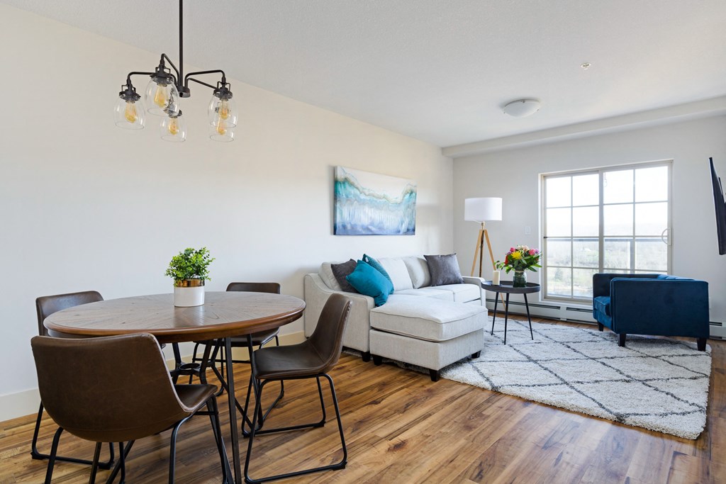 a living room with a couch and a dining room table with chairs