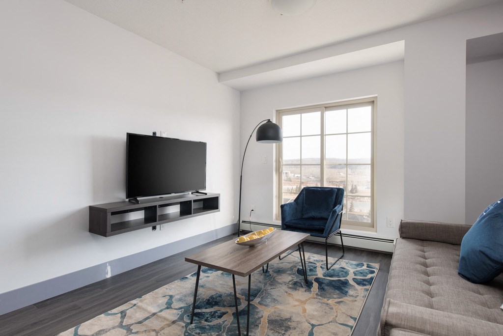 a living room with a couch and a table and a television