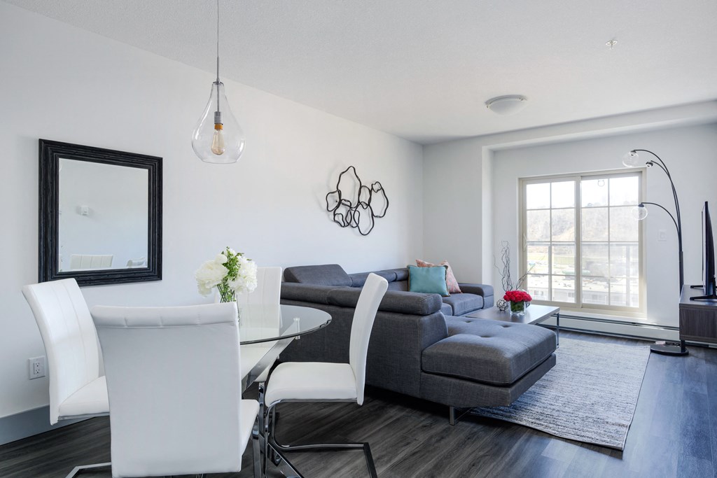 a living room and dining room with a couch and a table