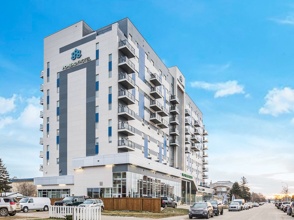 a large white building with cars parked in front of it