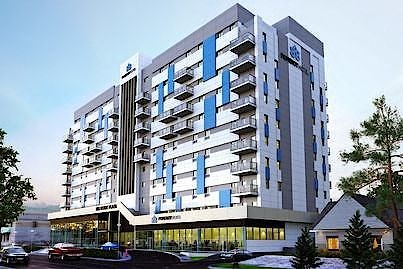 a tall building with a parking lot in front of it