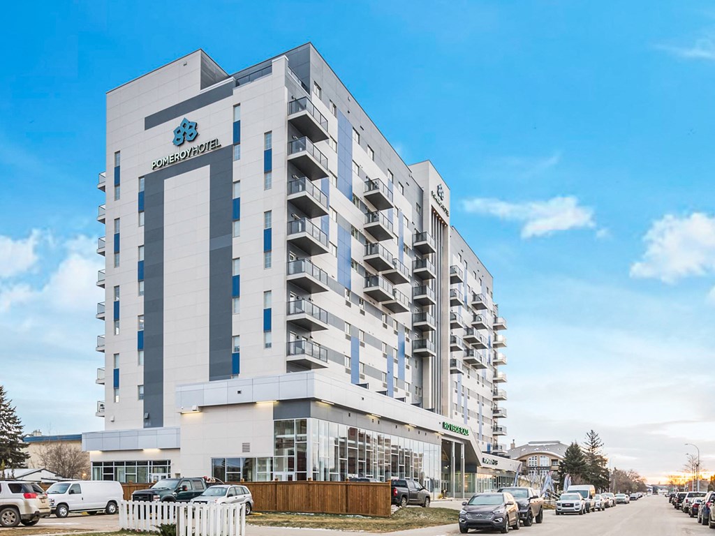 a large white building with cars parked in front of it