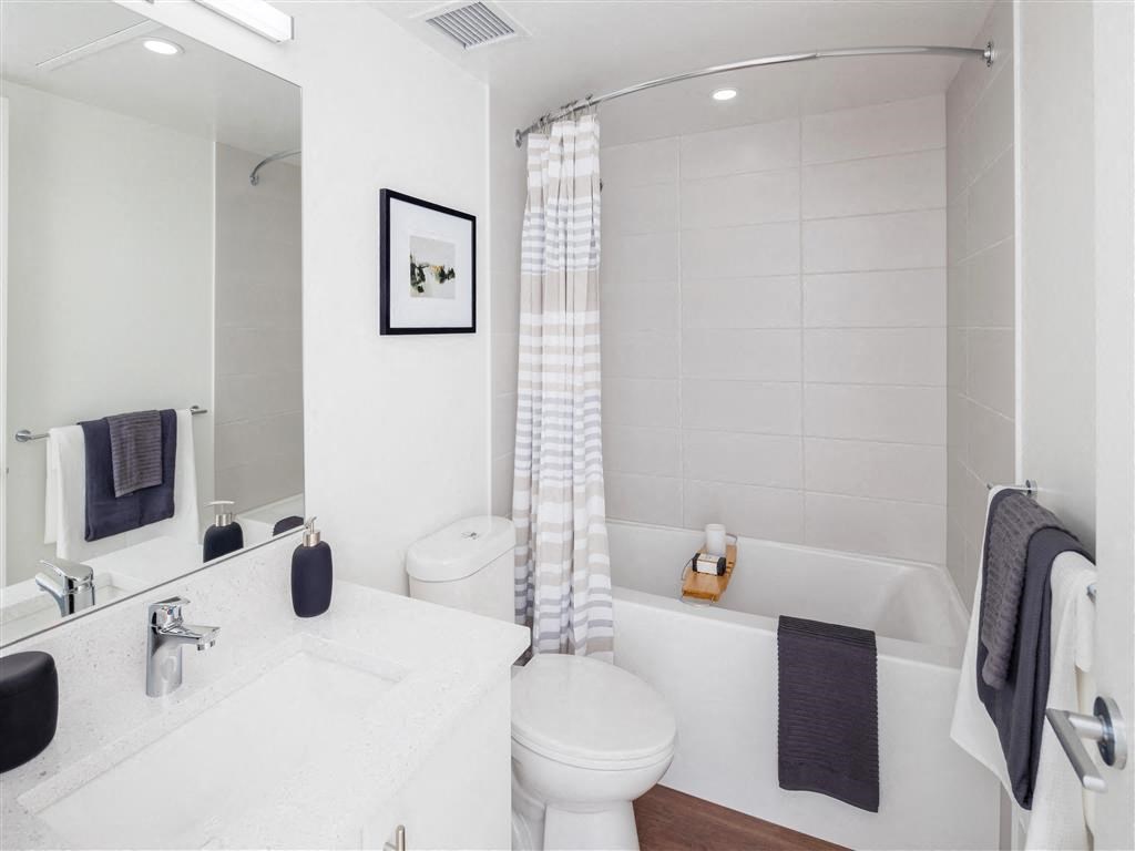 a bathroom with a toilet and a tub and a sink