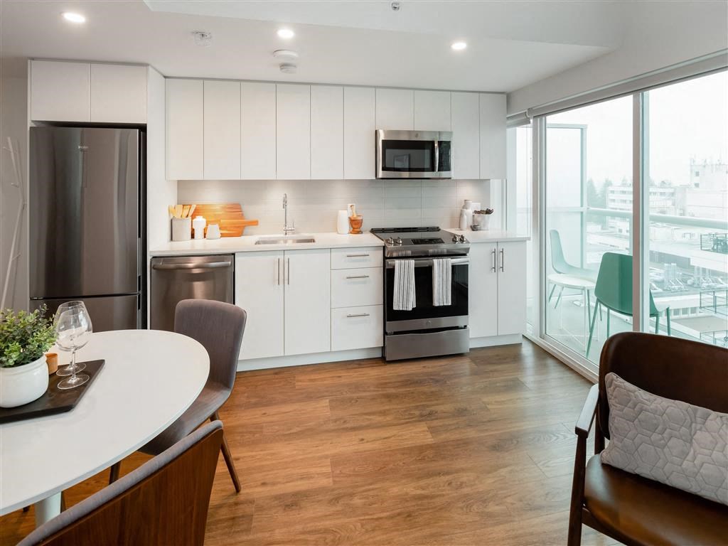 a kitchen and dining room with a large window