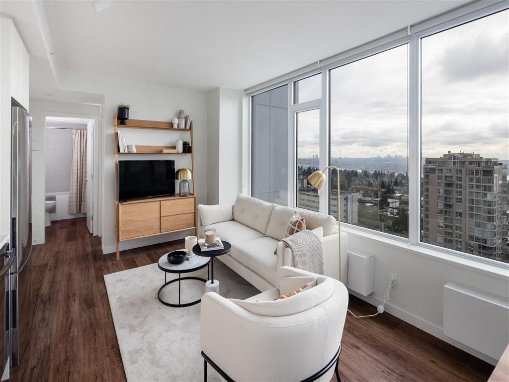 a living room with a large window and a white couch