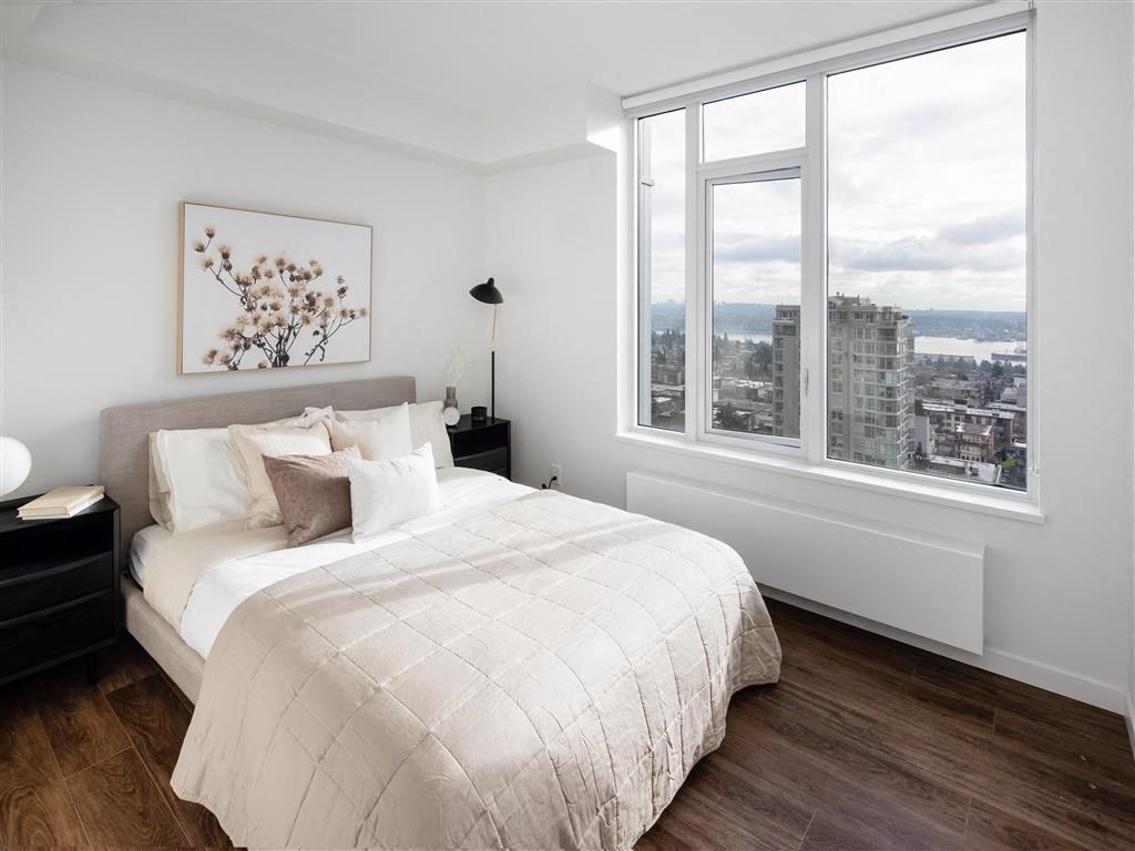 a bedroom with a bed and a large window