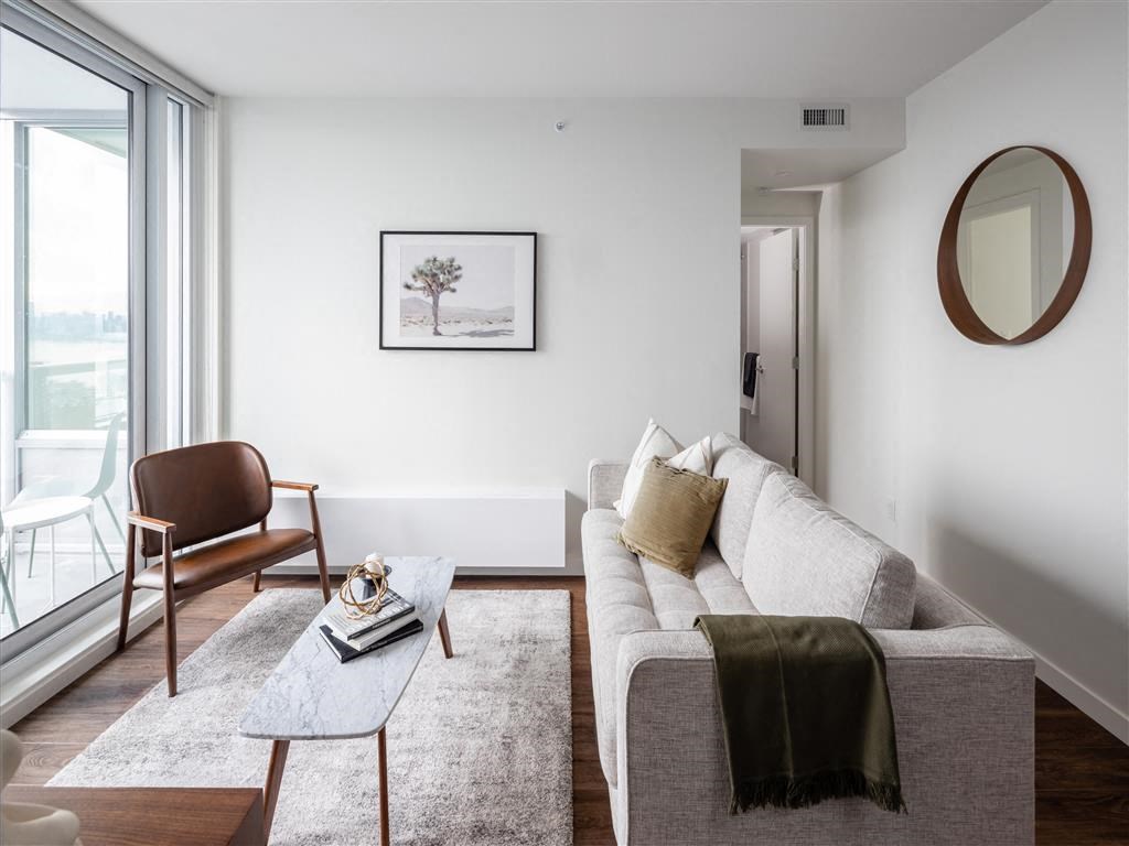 a living room with a white couch and a large window
