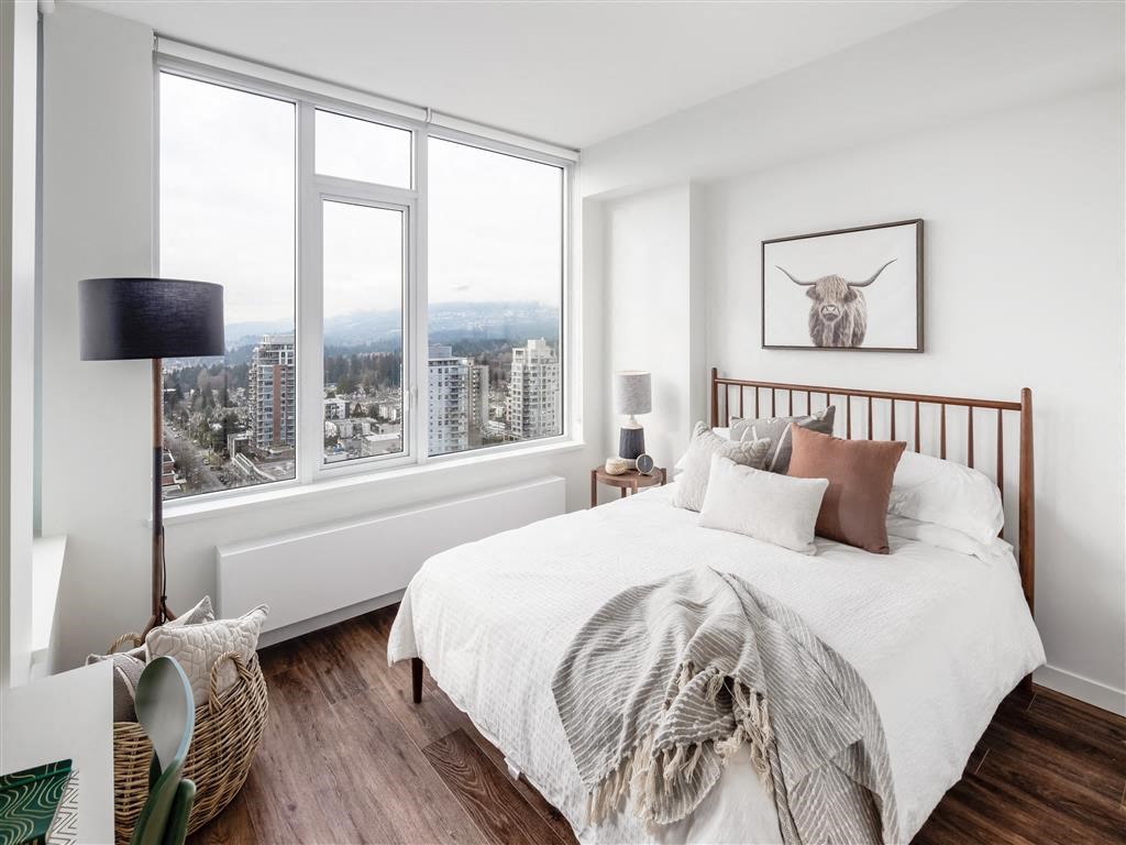 a bedroom with a bed and a large window