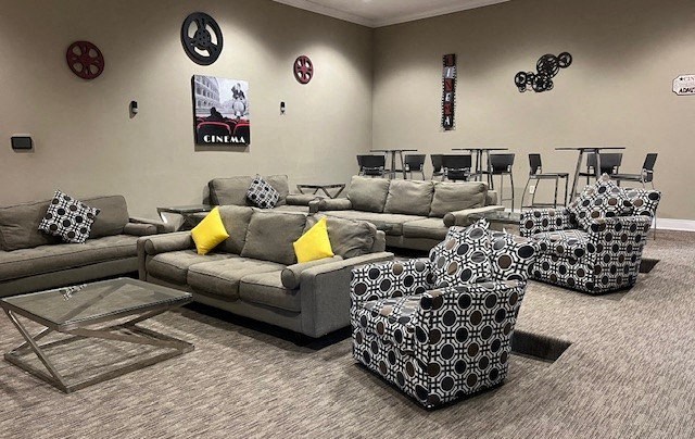 a living room with couches and chairs and a table