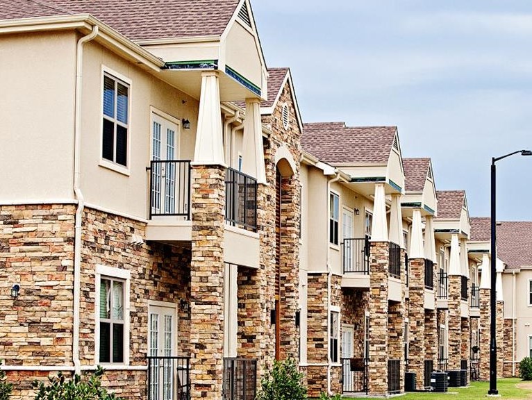 A row of houses with a pathway in the foreground.