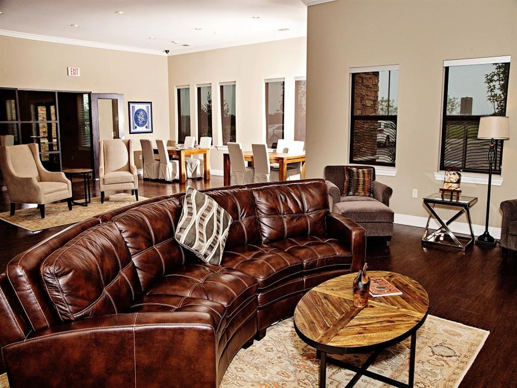 a living room with a leather couch and a table
