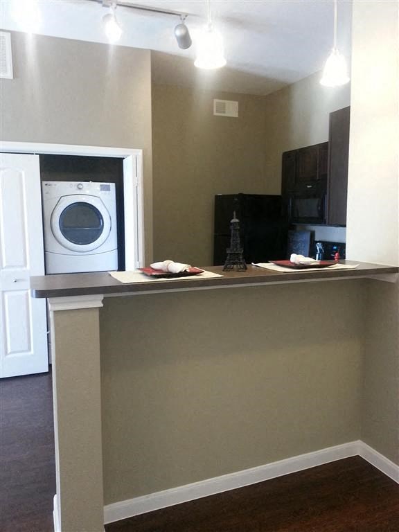 a kitchen with a washing machine and a counter