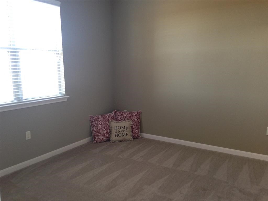 a living room with a couch and a window