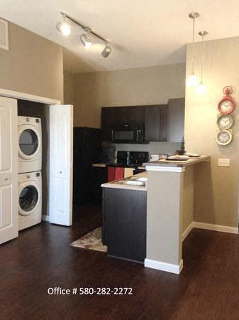a kitchen with a washer and a dryer in it