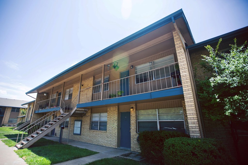 the exterior of an apartment building with a staircase