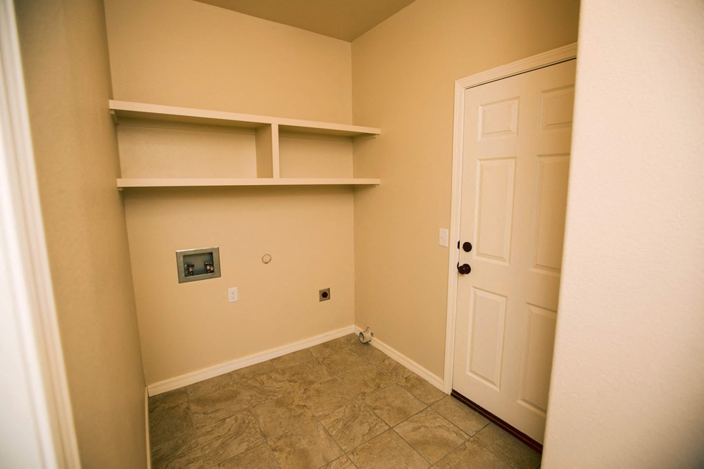 a room with shelves and a door and a closet