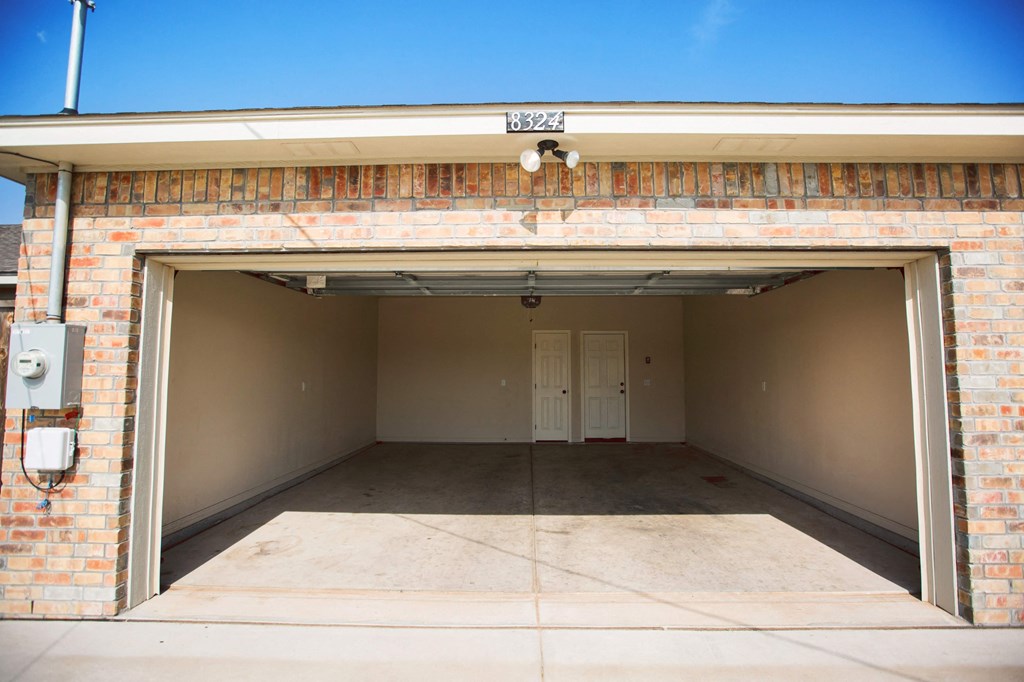 the inside of a garage with a door open
