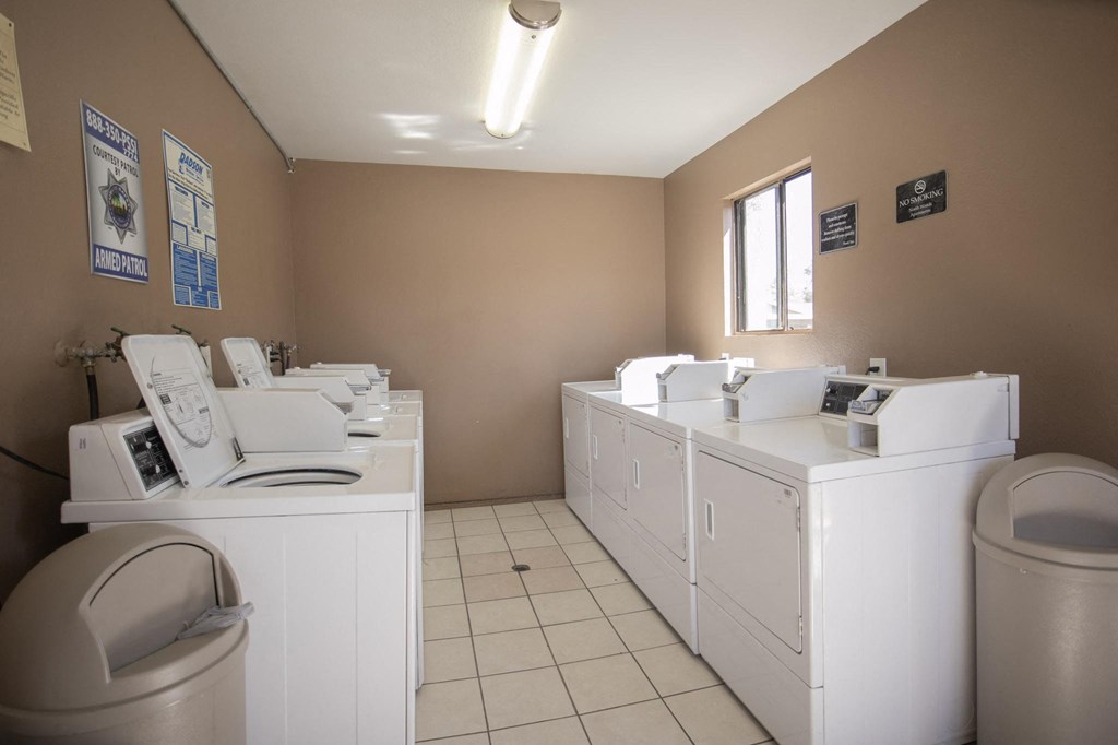 a laundry room with washers and dryers and a sink