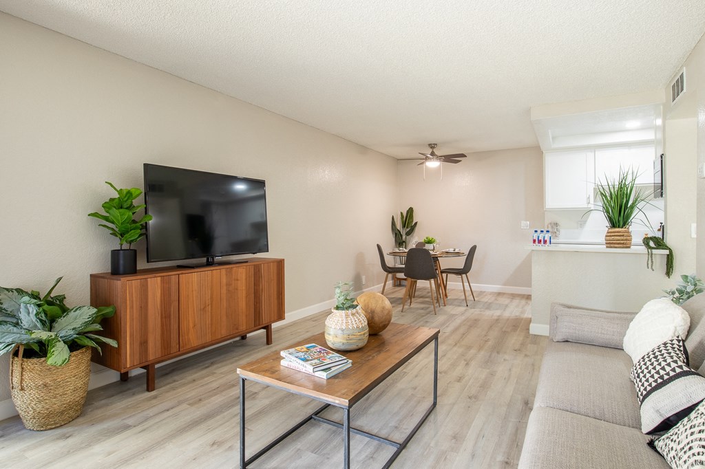 a living room with a tv and a dining room in the background  at Metro 3610, California
