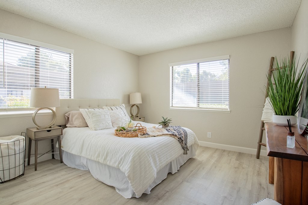 a bedroom with a bed and two windows  at Metro 3610, Riverside, California