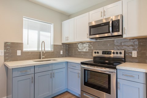 A kitchen with a stove top oven and microwave above it.
