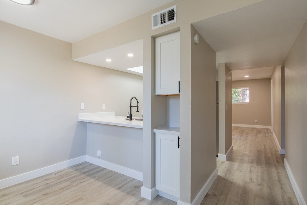a kitchen with white cabinets and a white counter top