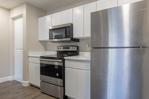 a kitchen with stainless steel appliances and a stainless steel refrigerator