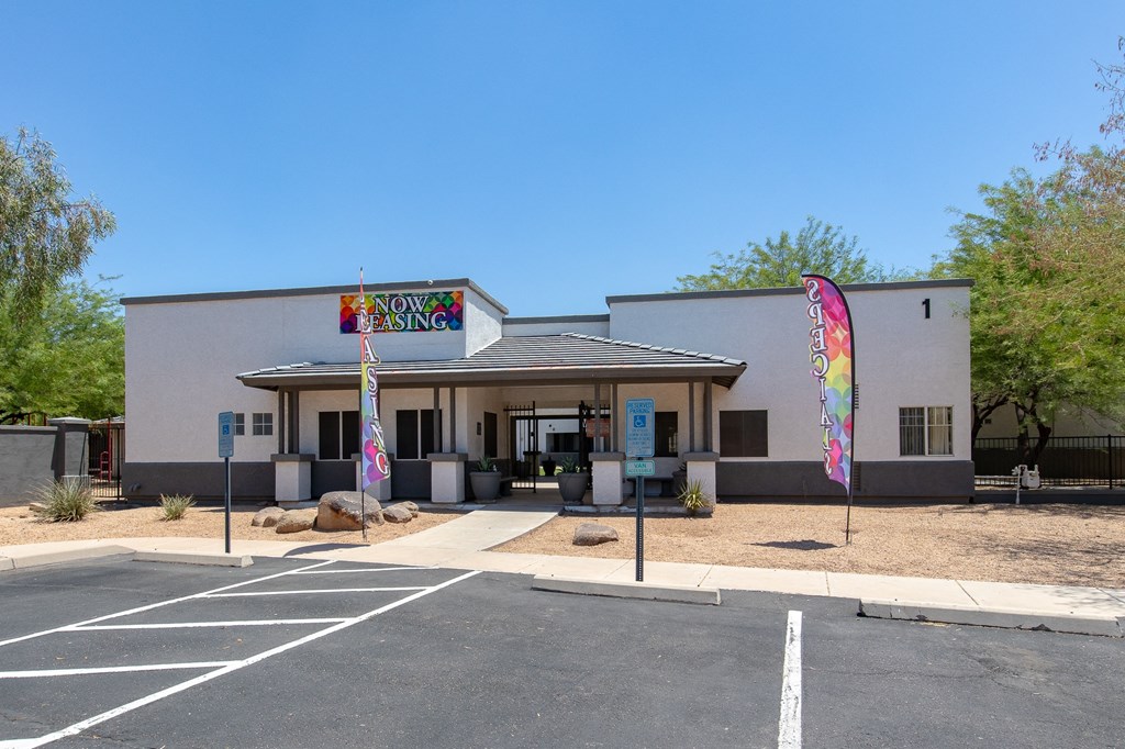a white building with a colorful sign on the front of it