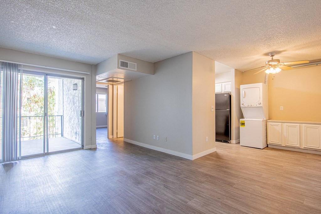 an open living room with a door leading to a balcony