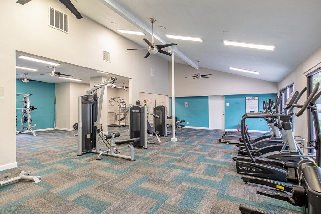 a gym with weights and cardio equipment at the flats