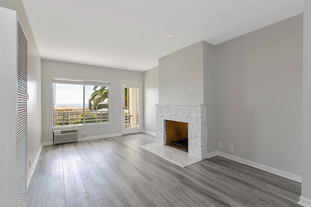 a living room with a fireplace and a window