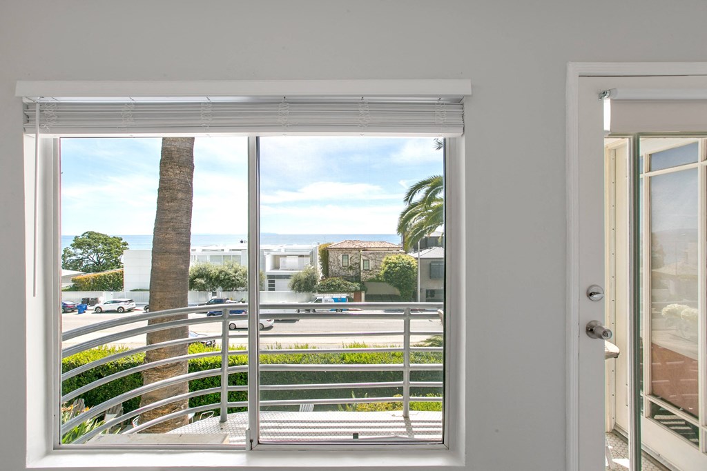 a view of the ocean from a window of a house