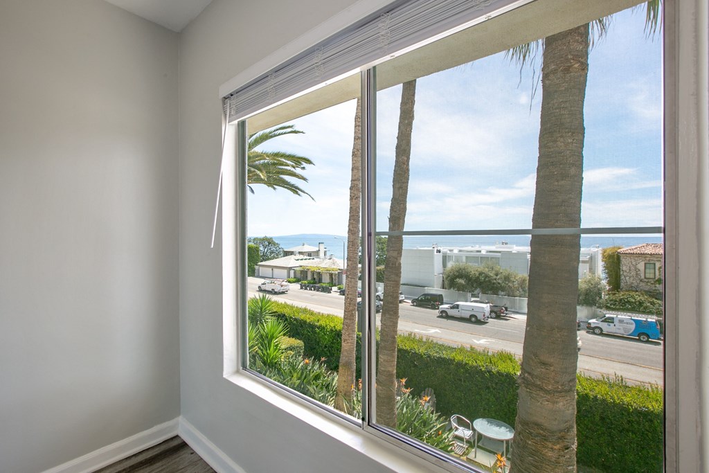 a view of the ocean from a window of a house