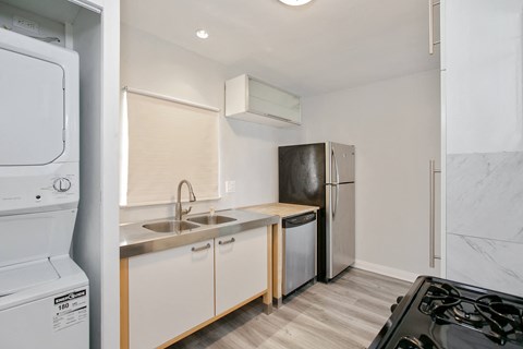A small kitchen with a black stove top oven.