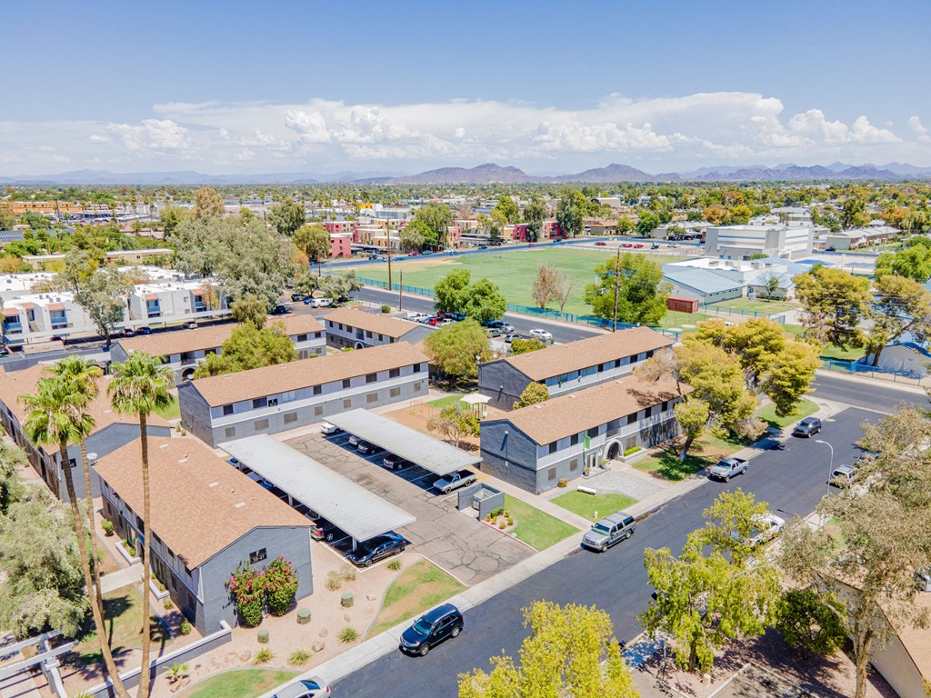 an aerial view of a city with buildings and a parking lot
