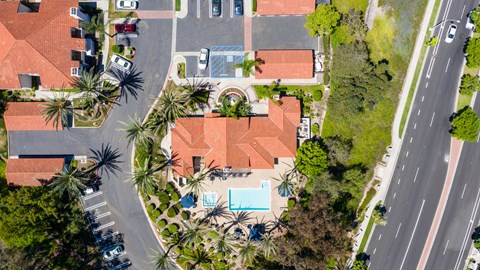 a birds eye view of a house with a pool and palm trees