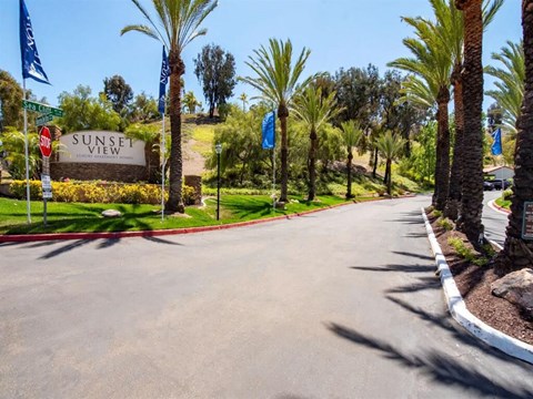 the sign for sunset view at the entrance to the sunsets resort sign with palm