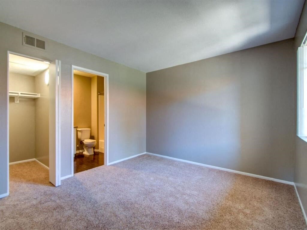 an empty room with a toilet and a closet