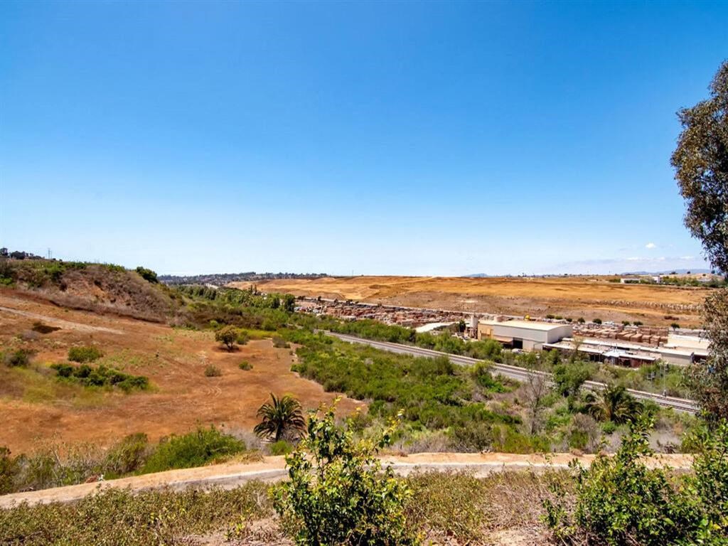 a view of a field with a blue sky in the background