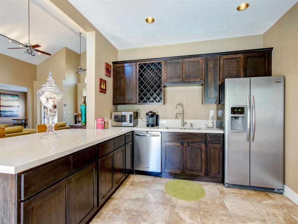 a kitchen with wooden cabinets and stainless steel appliances