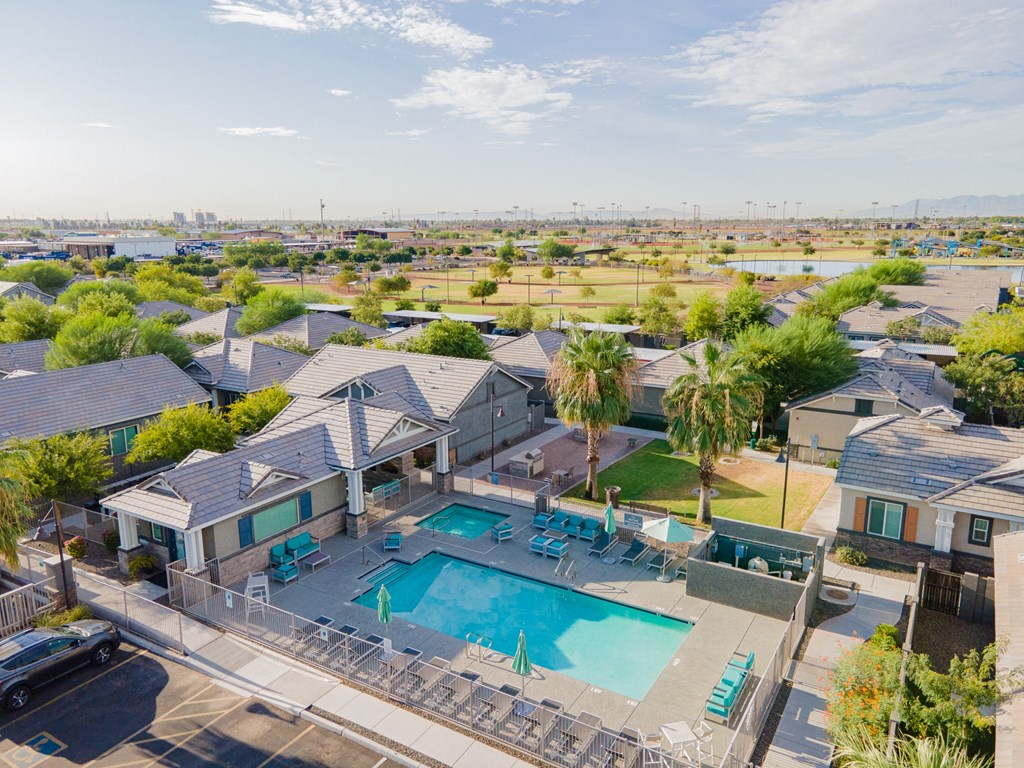 a group of houses with a swimming pool and patio furniture