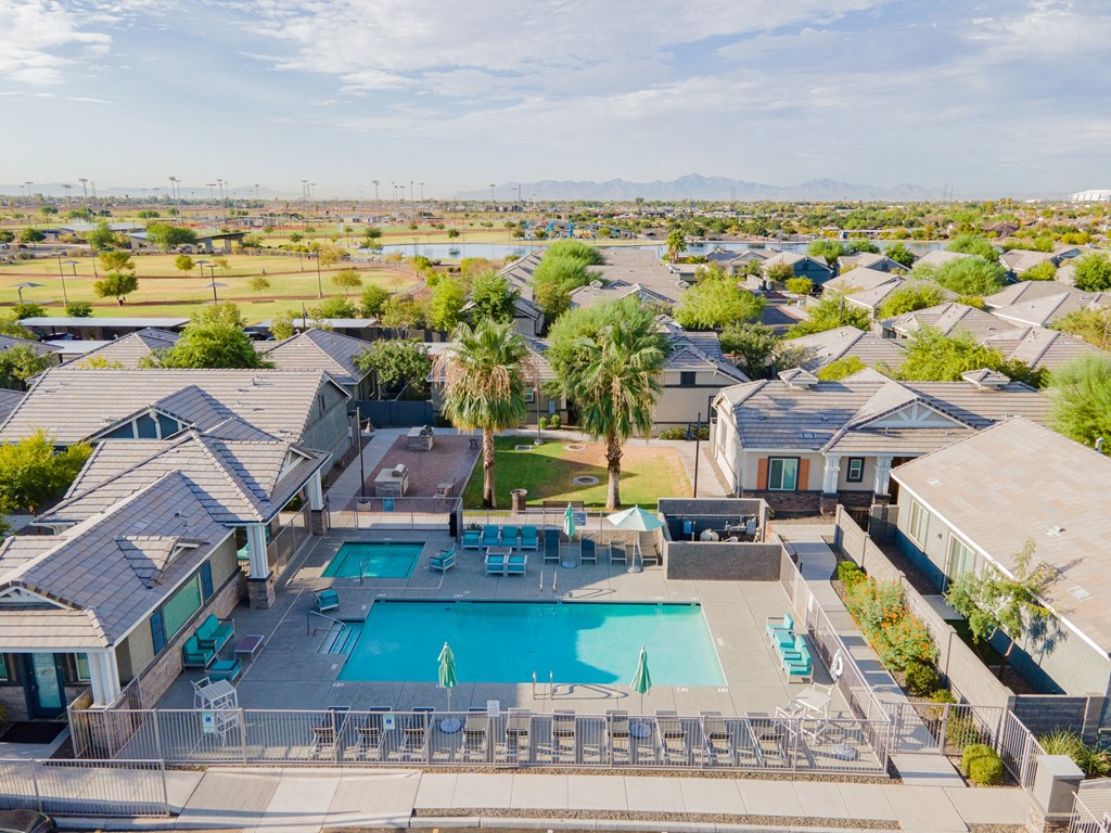an aerial view of a swimming pool and a group of houses