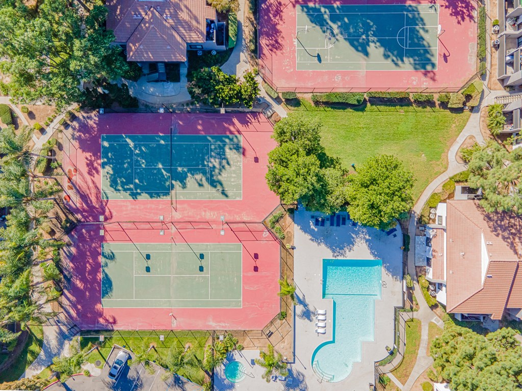 a property with a tennis court and a pool on the ground