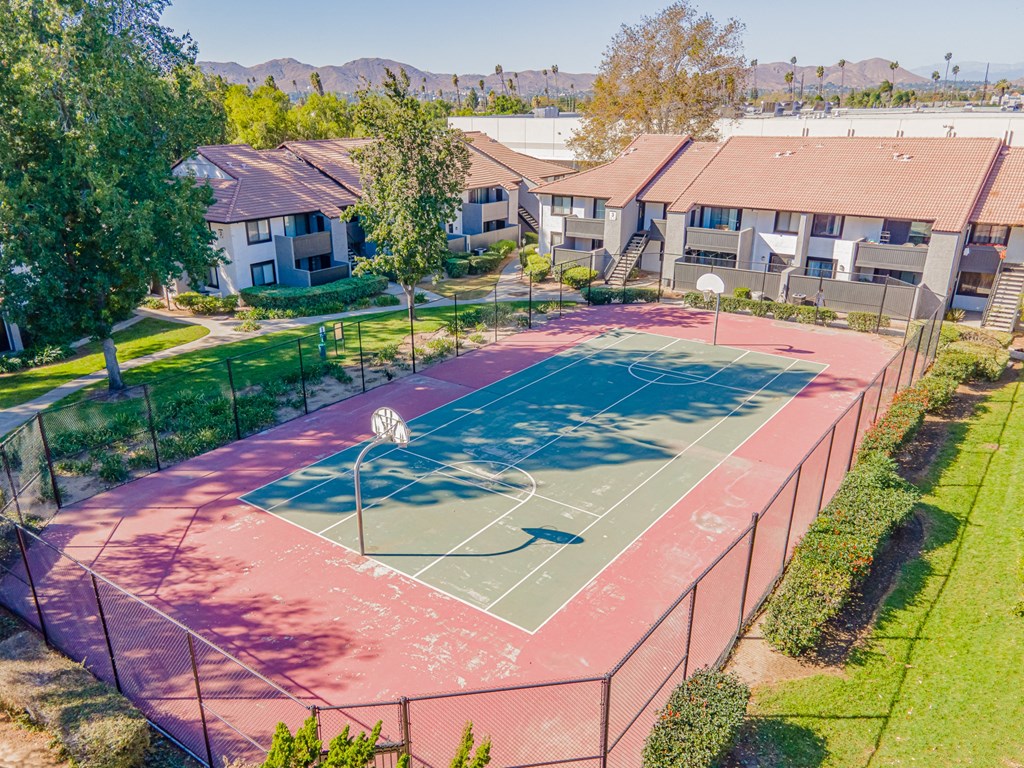 a basketball court in a neighborhood with houses