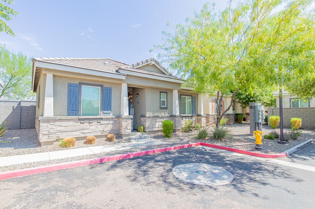a small house with a red curb in front of it