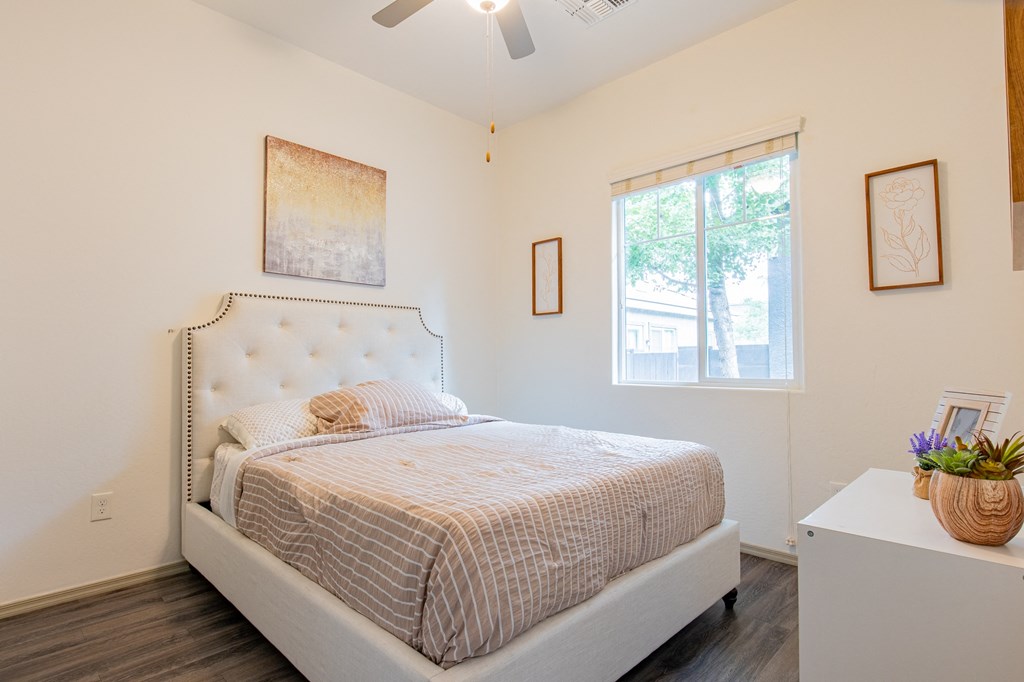 a bedroom with a bed and a window