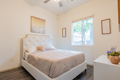 a bedroom with a bed and a window