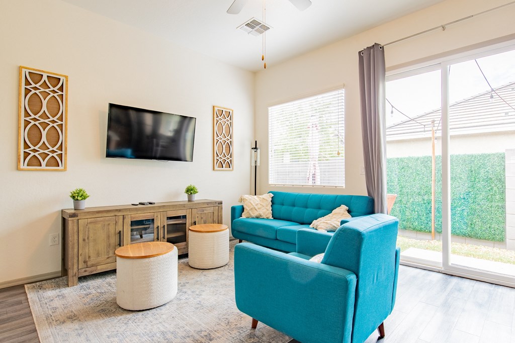 a living room with a blue couch and a tv