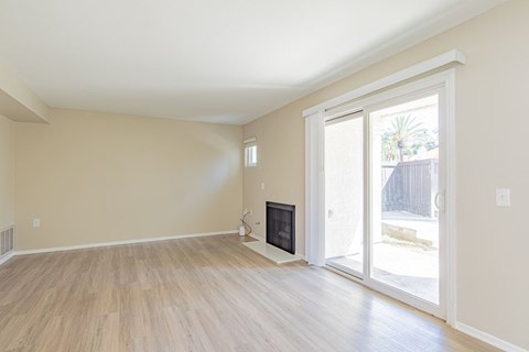 a living room with a fireplace and a sliding glass door