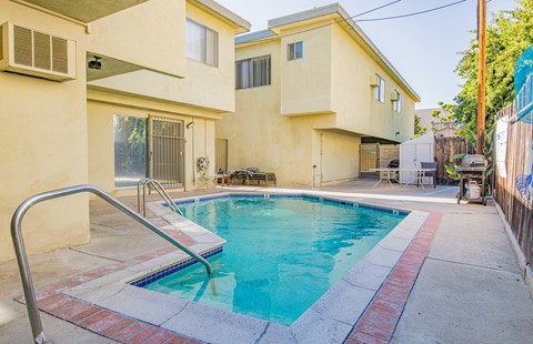A small residential pool with a metal ladder.